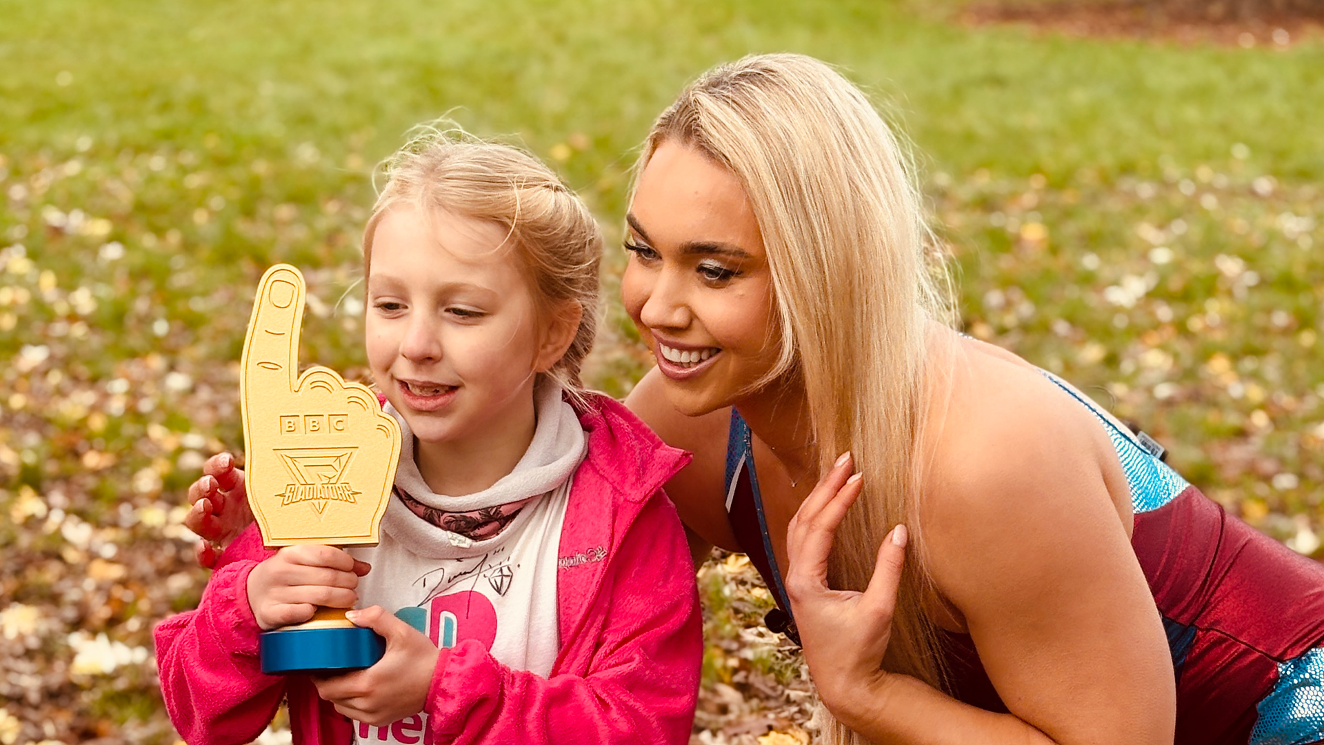 poppy and diamond holding an award.