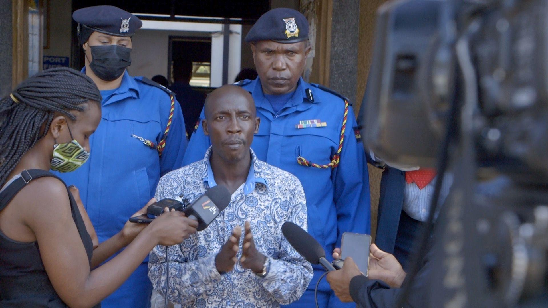 Man speaking to journalists