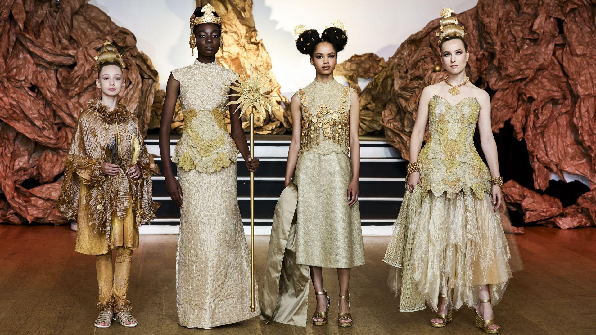 four models wearing golden outfits