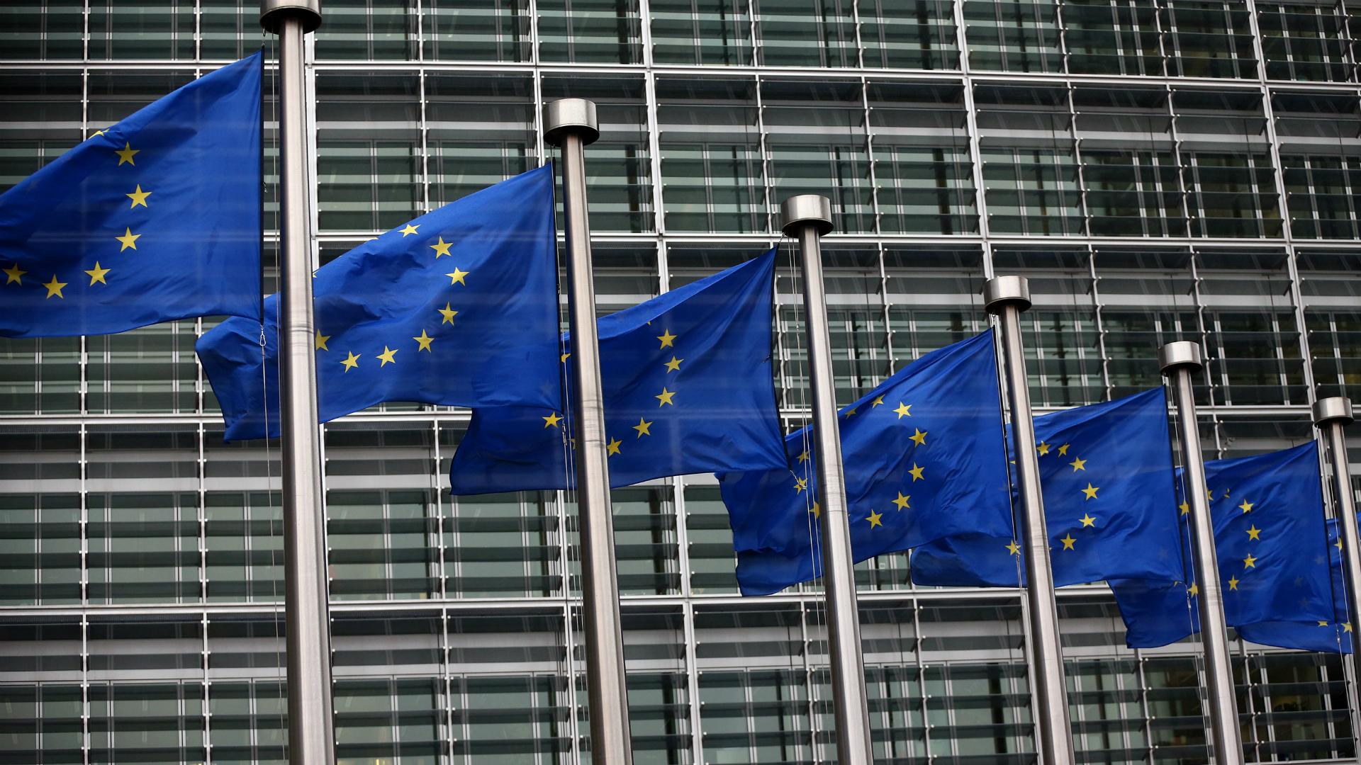 EU flags waving outside European Commission building in Brussels