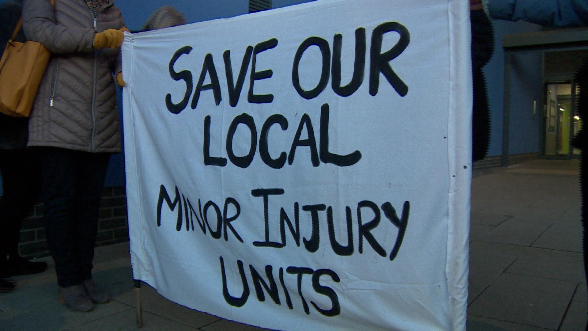 A sign that reads: SAVE OUR LOCAL MINOR INJURY UNITS