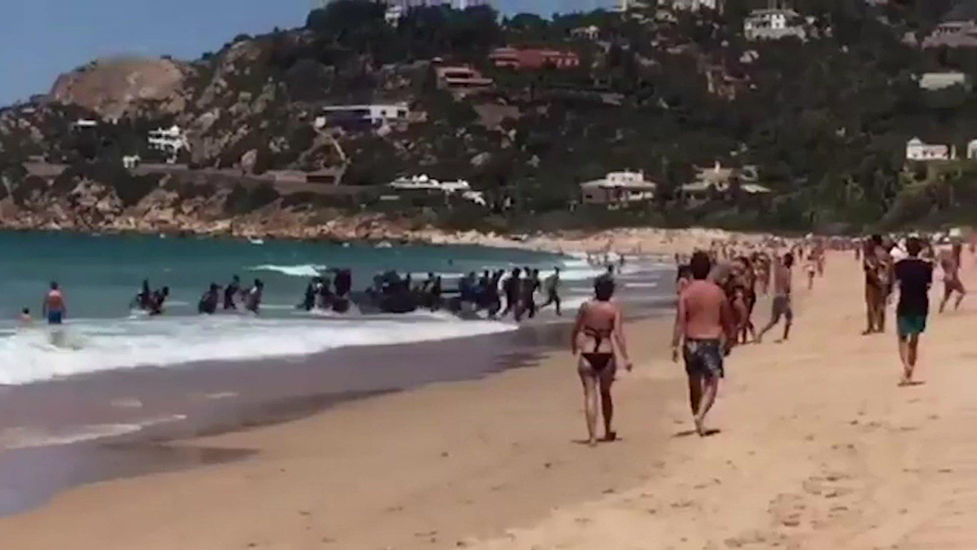 Screen grab of video shows moment migrants arrive at beach in southern Spain