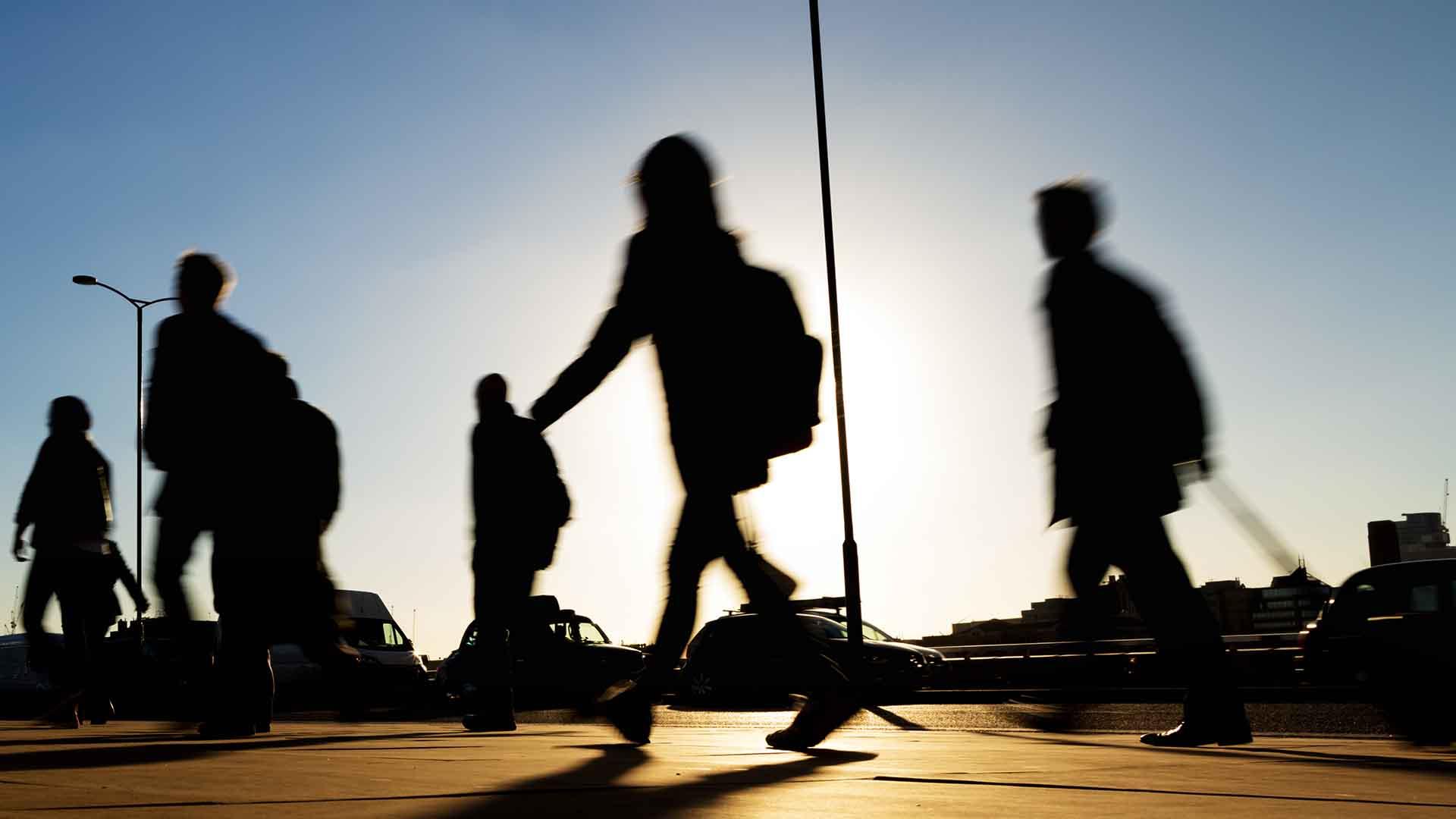 People walking across bridge in outline