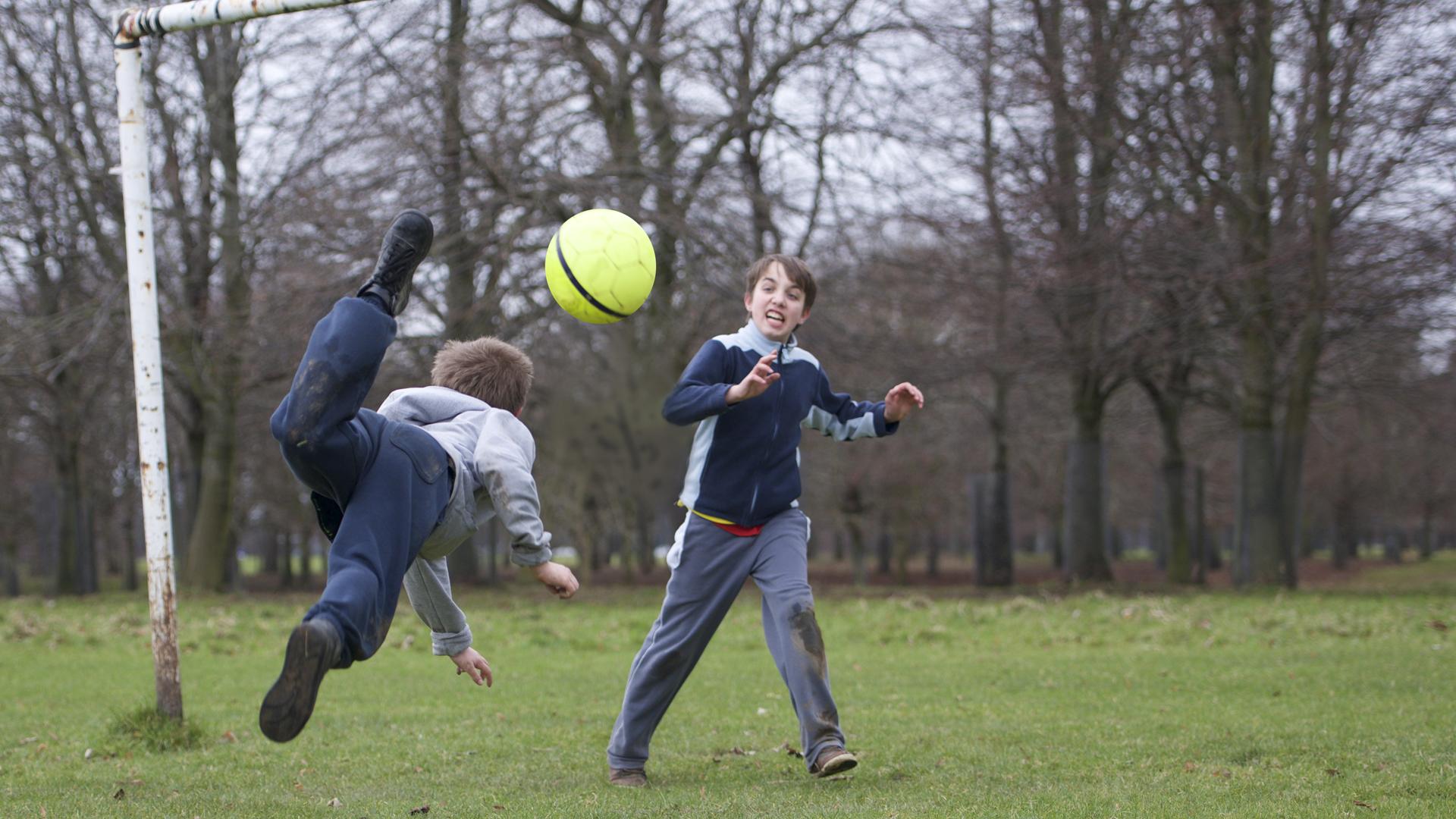 Two boys playing football