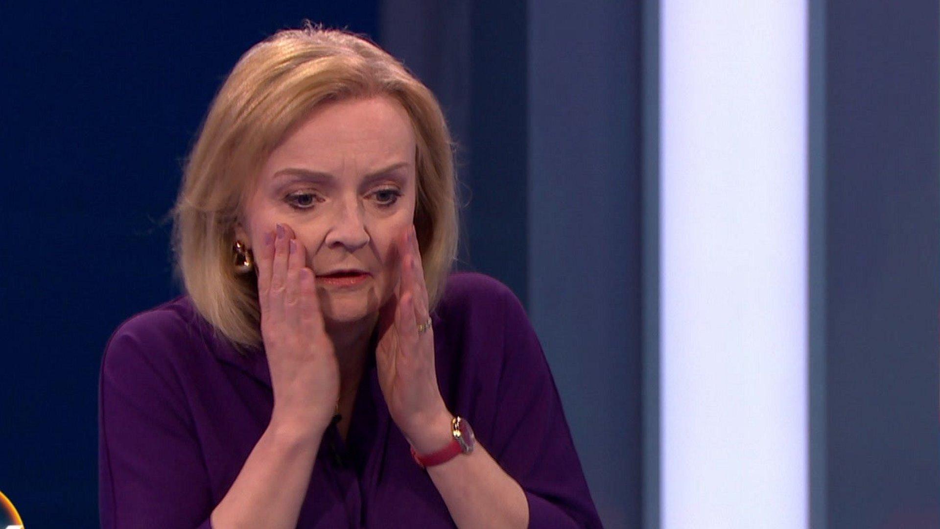 Liz Truss reacts after presenter faints