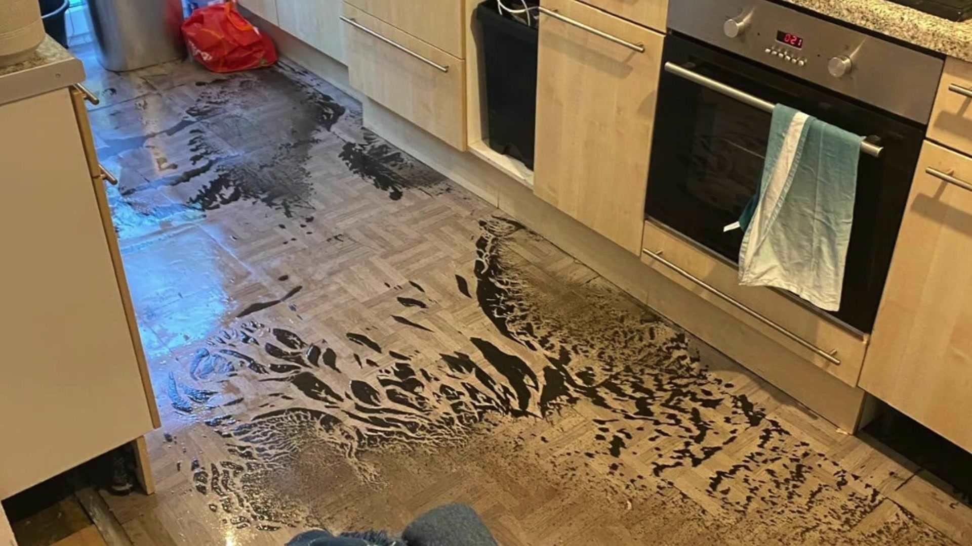 Kitchen covered in dirty water and sewage