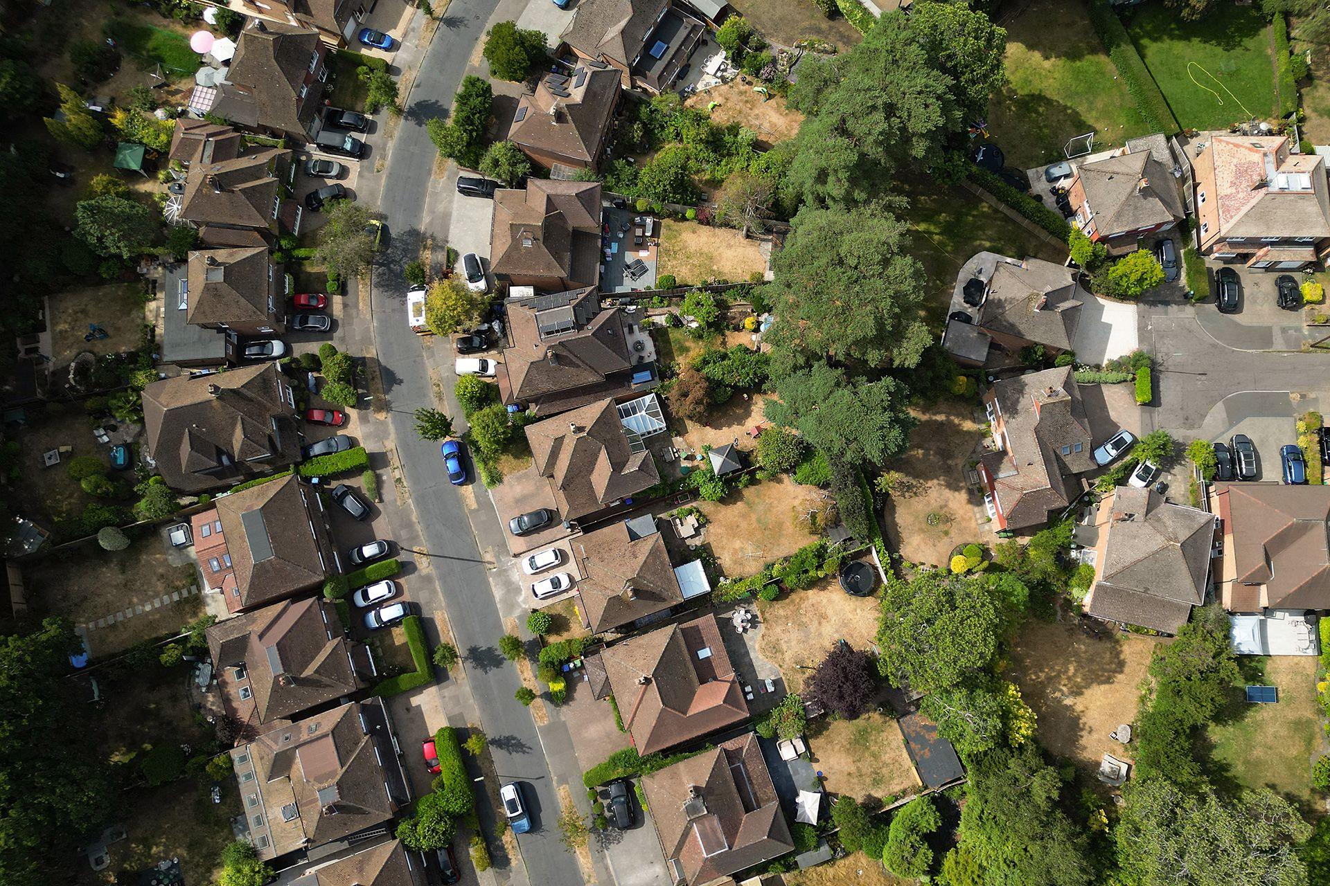 An aerial view shows brown grass in gardens of a cul-de-sac in Woking, Surrey, on 25 July.