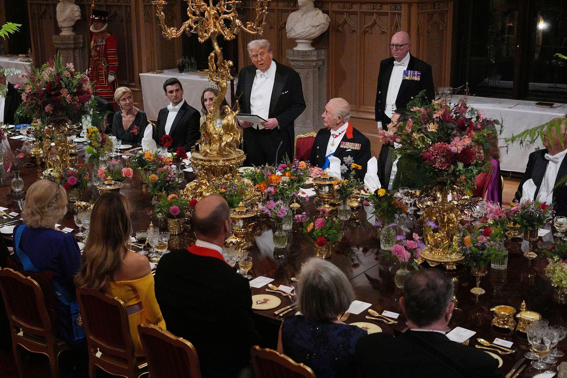 US President Donald Trump delivers his speech as King Charles III and the Princess of Wales listen during the state banquet