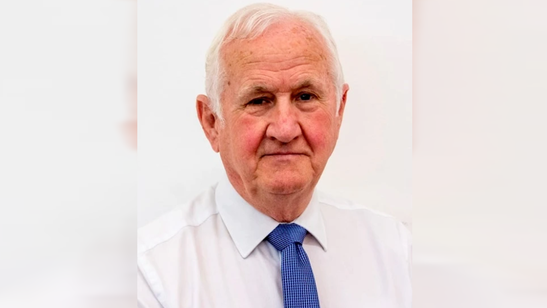 Councillor Duncan McGregor, a man with silver hair, wearing a white shirt and blue tie.