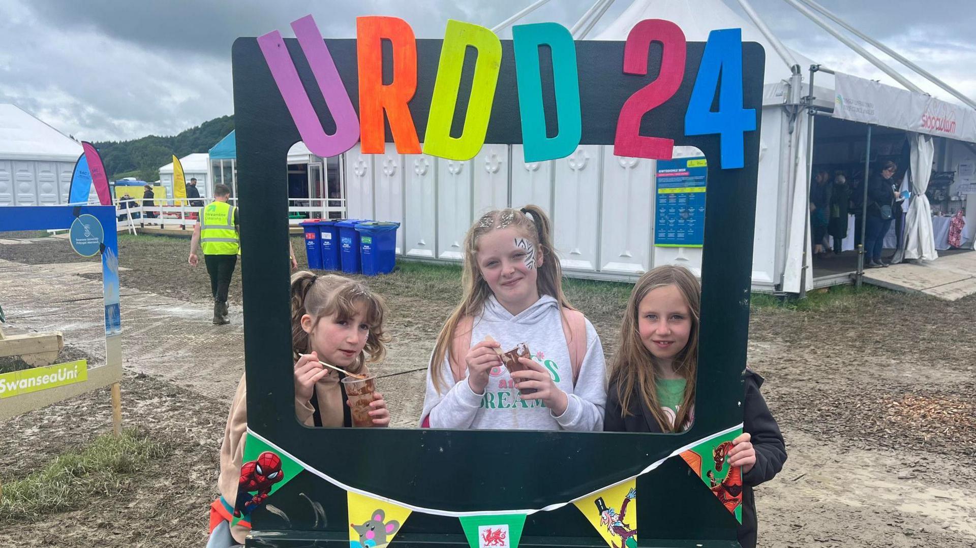 Annie, Seren and Phoebe with Urdd 2024 sign