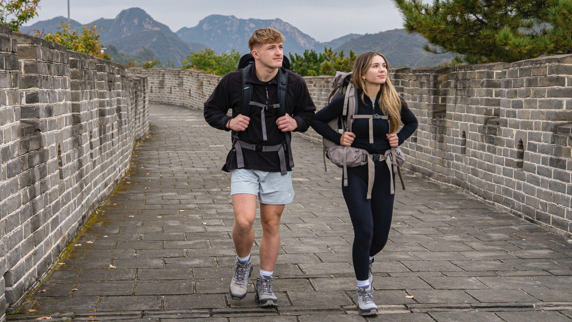 Fin an Sioned, two competitors on Race Across the World, walk along a brick path in China.