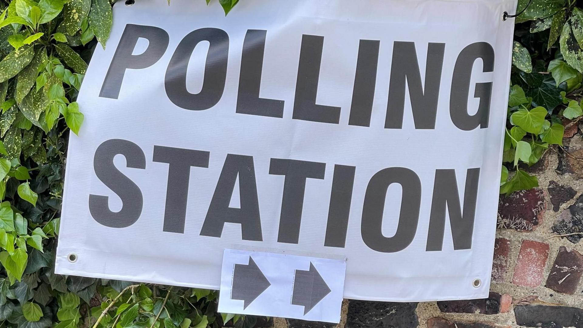 Black and white polling station sign