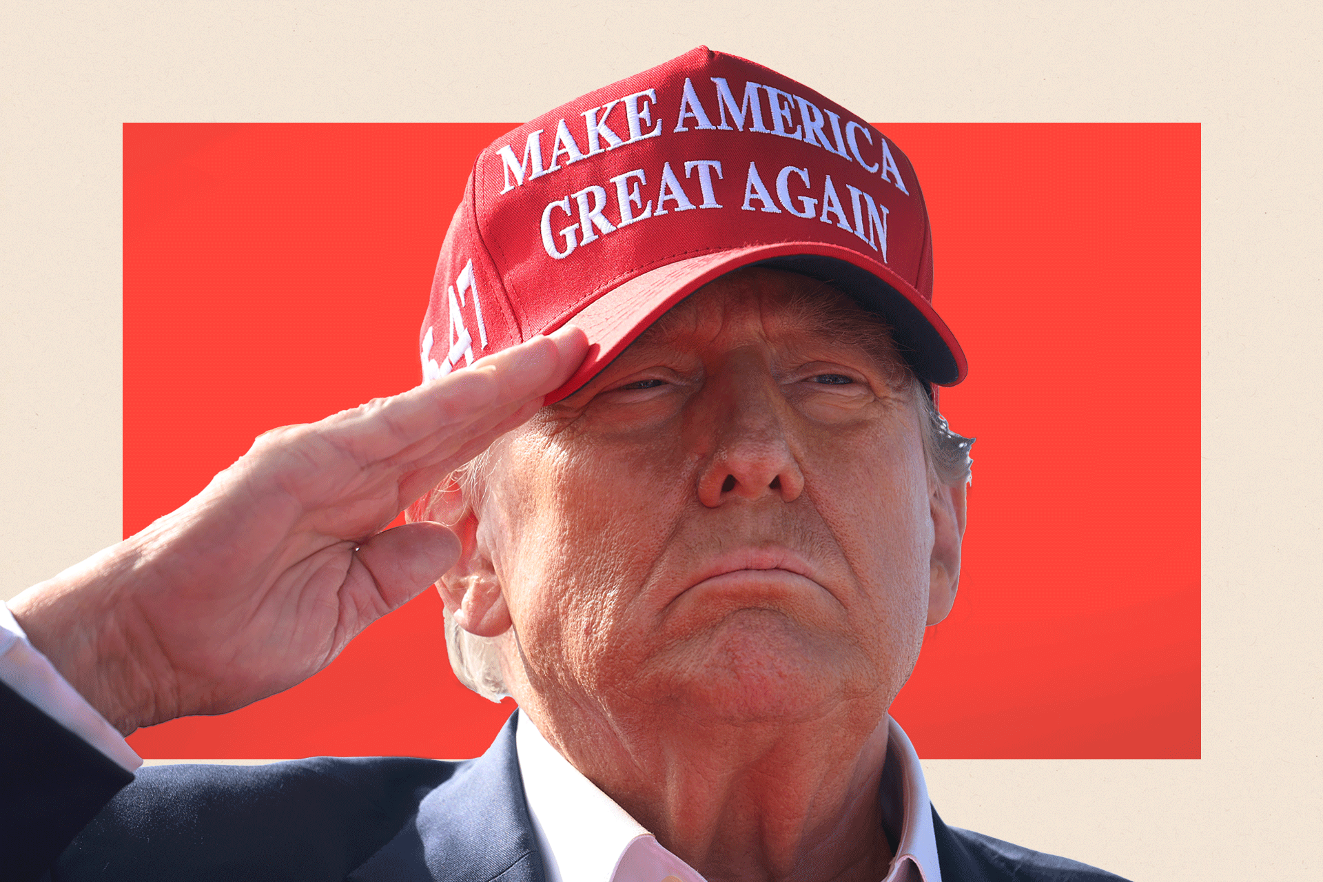 A close up of Donald Trump saluting while wearing a red hate with the words 'Make America Great Again'