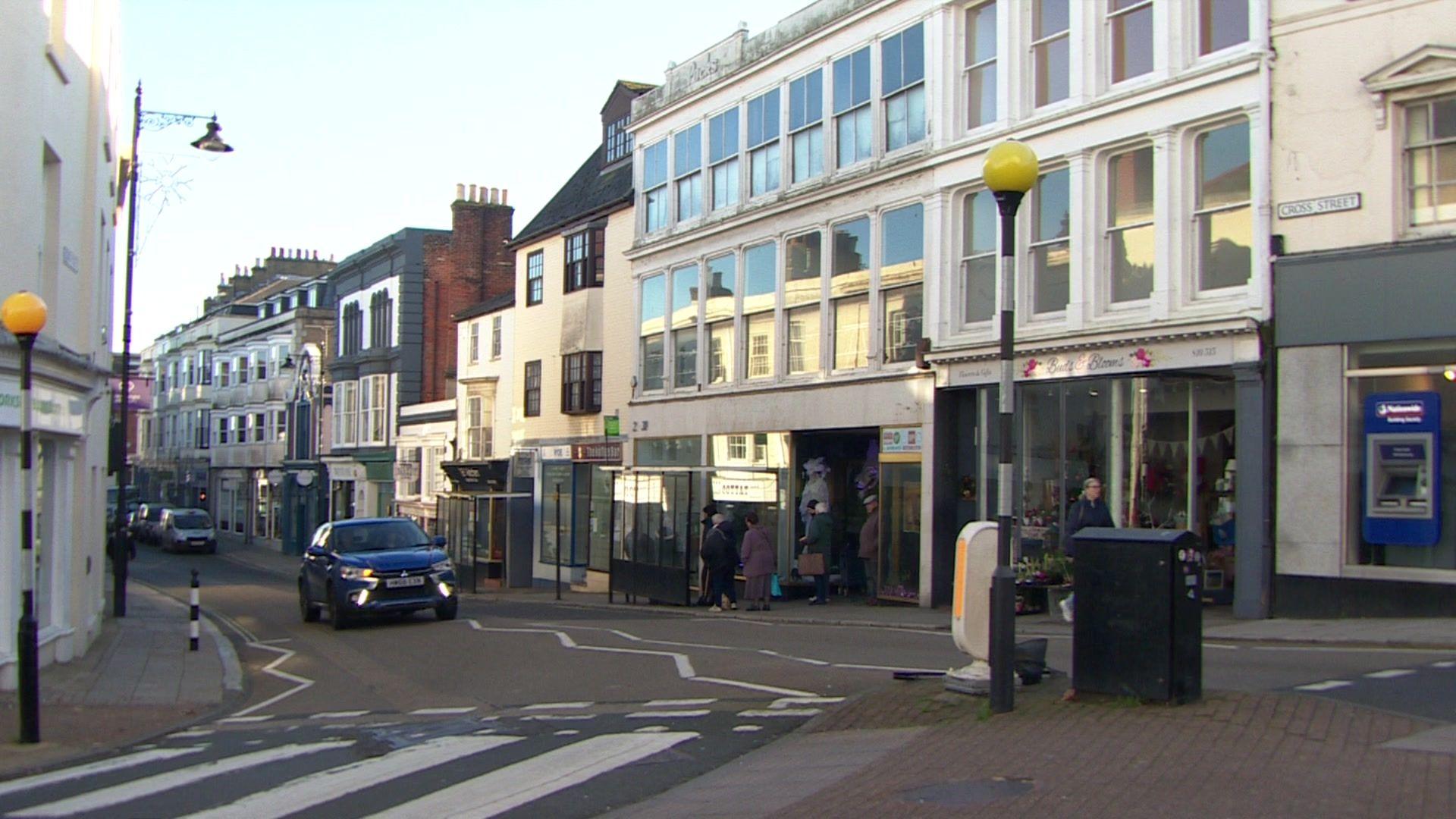 A picture showing a major junction of Union Street, Cross Street and High Street in Ryde with variations in architecture, some modern buildings and some much older.