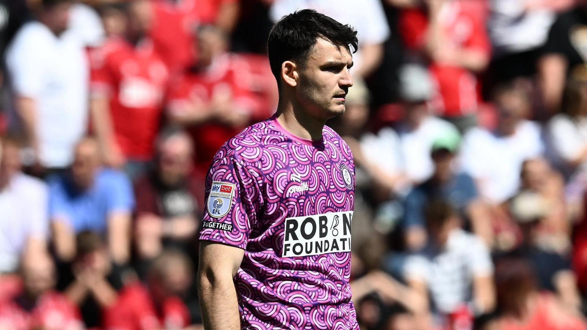 Max O'Leary standing on the pitch looking during a match