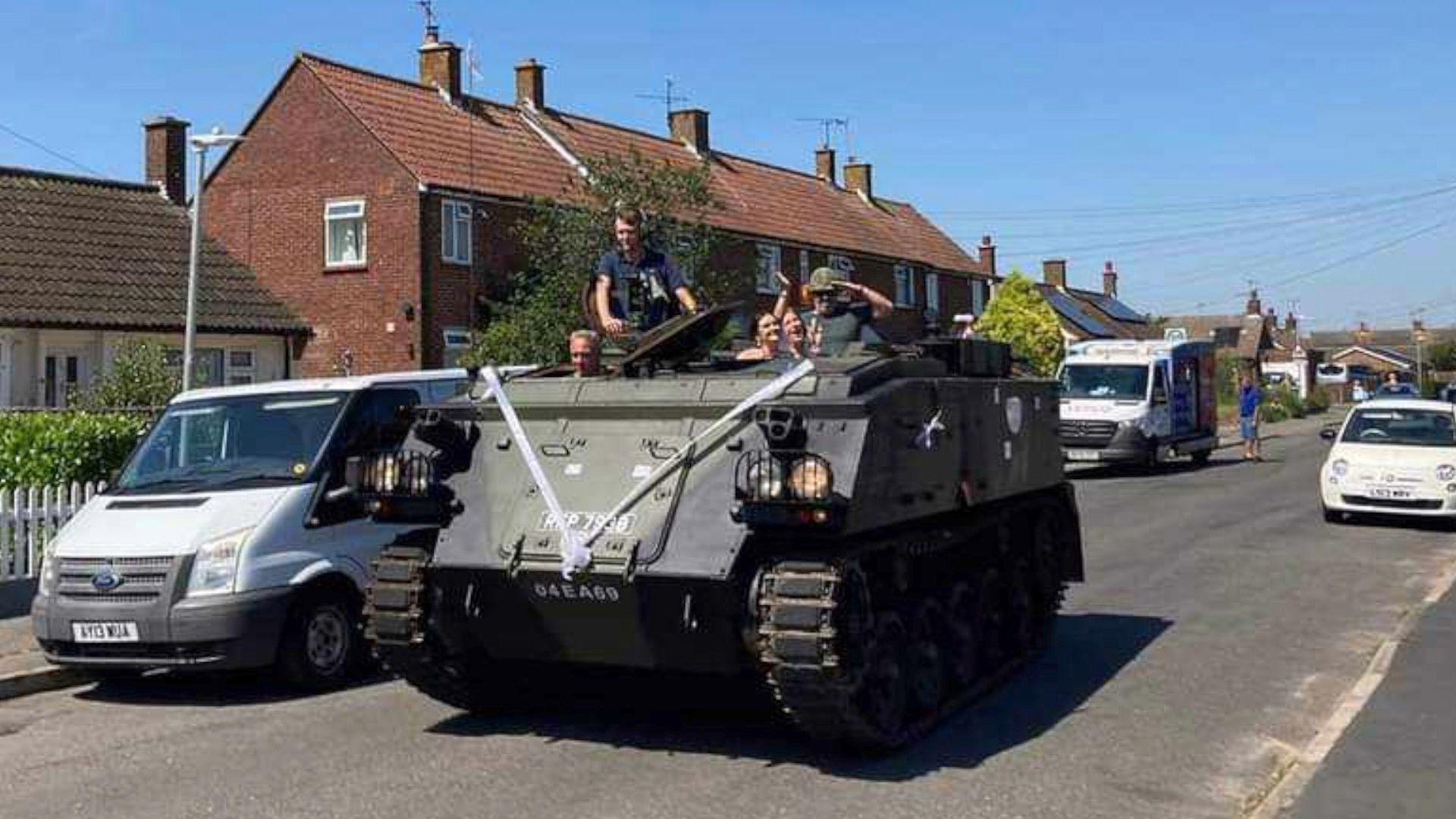 A tank with a wedding bow on the front driving through Burnham-on-Crouch