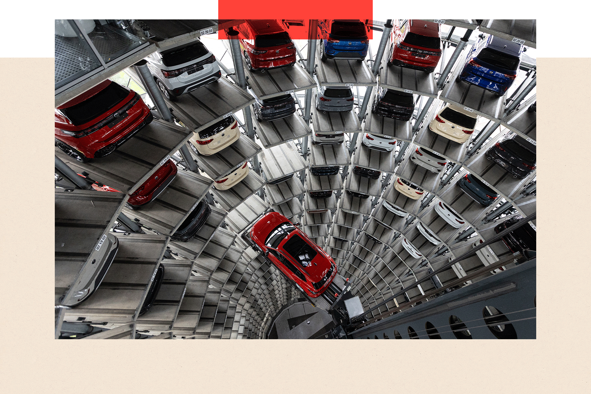 A Volkswagen Tiguan car stands on an elevator platform inside one of the twin display towers at the Volkswagen factory - cars line up the tower 