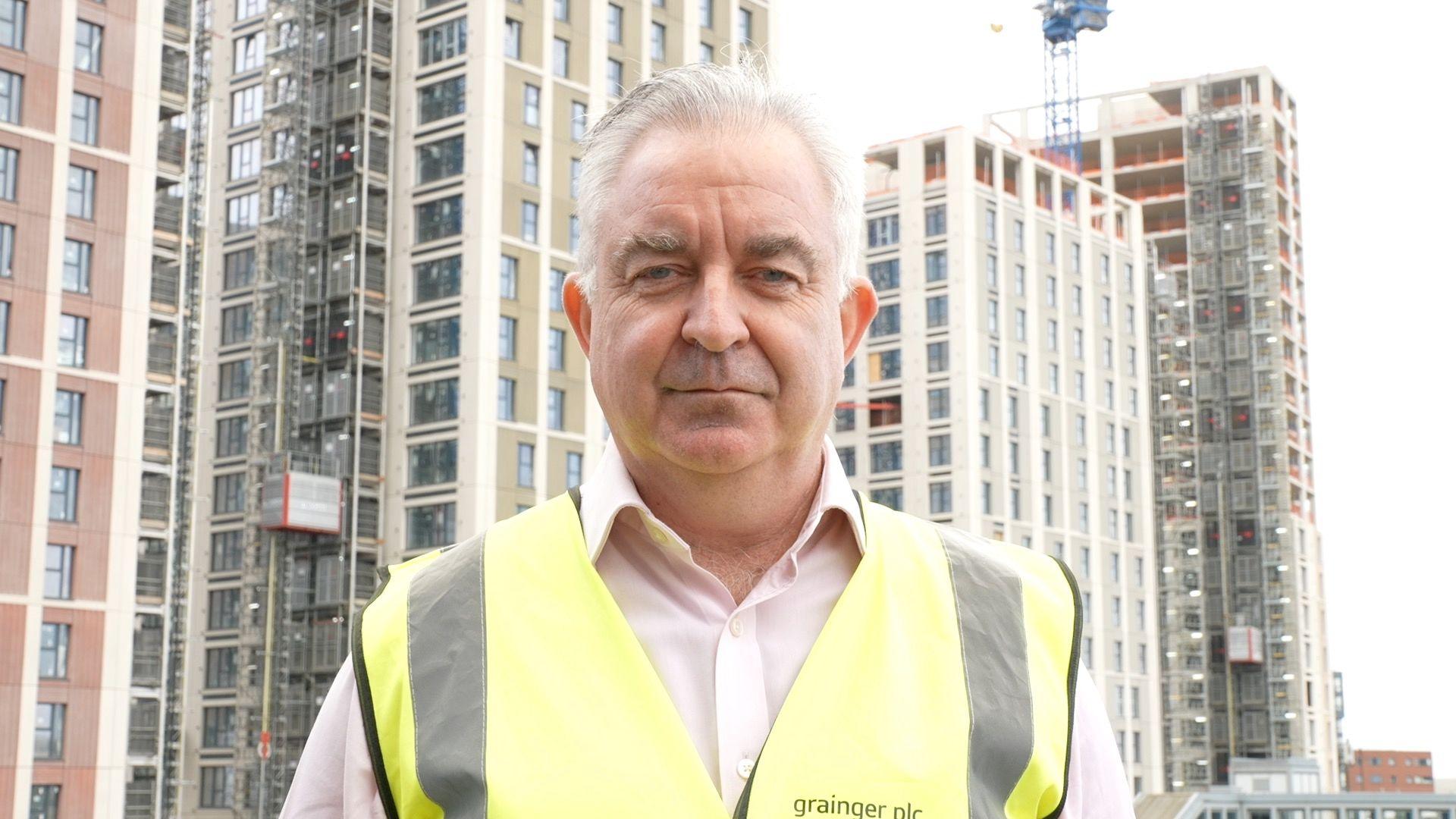 Mike Keaveney, a man in a hi-viz tabard, looks at the camera