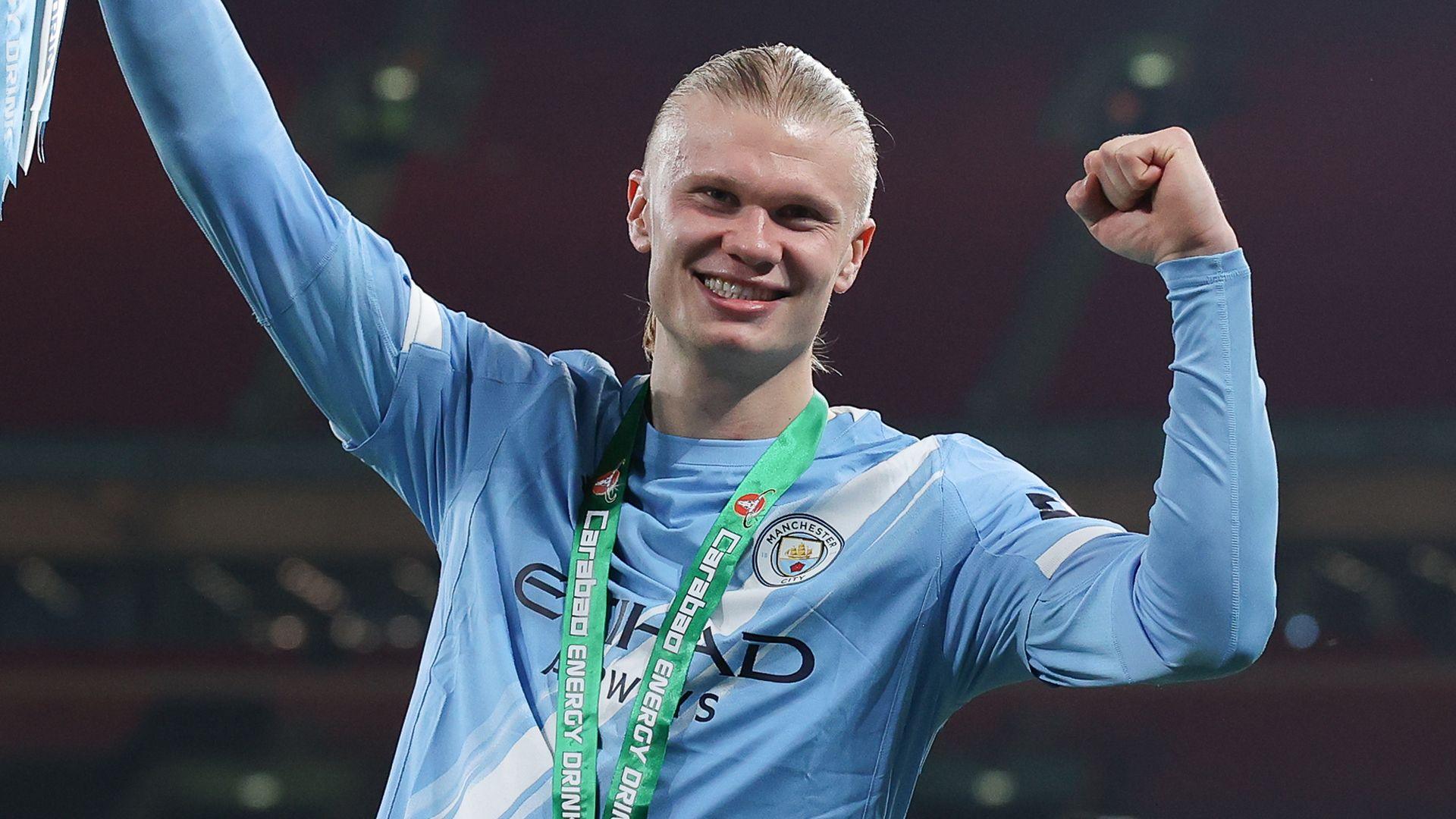 haaland smiling wearing his football kit.