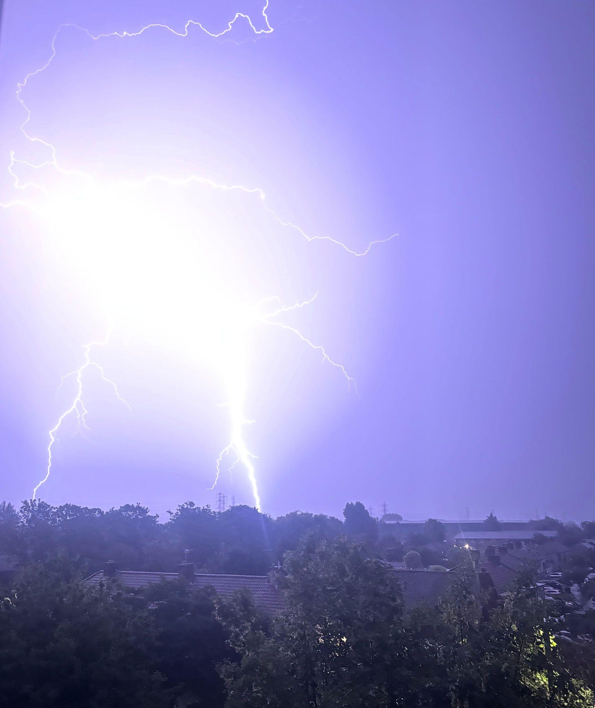 Lightning lights up the sky in Waltham Cross, Hertfordshire