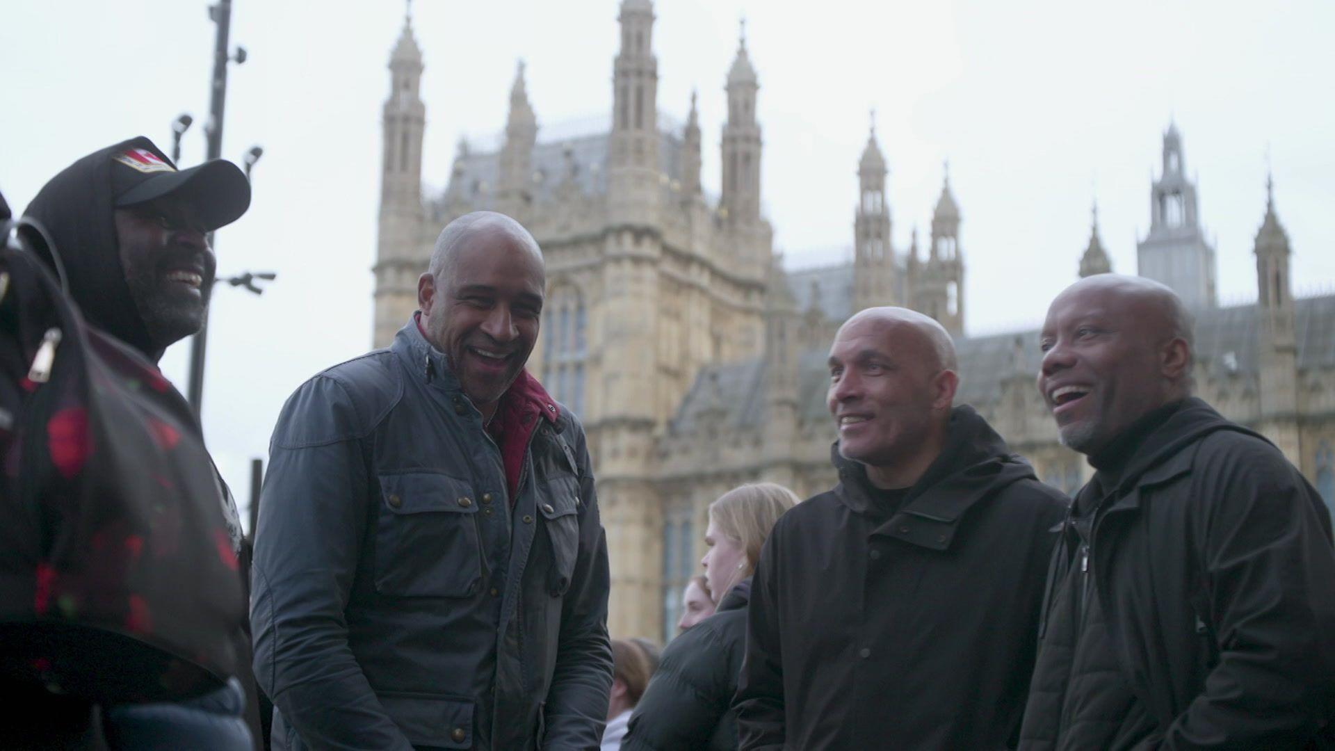 Members of the V11 group standing outside the Houses of Parliament for a campaign march