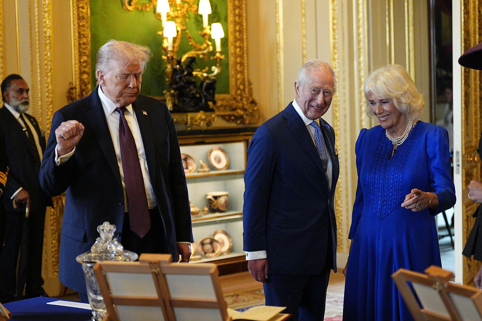 US President Donald Trump (L) and King Charles III view items on display during a visit to the Royal Collection exhibition, in the Green Drawing Room during the State visit by the President of the United States of America at Windsor Castle on September 17, 2025 in Windsor, England. 