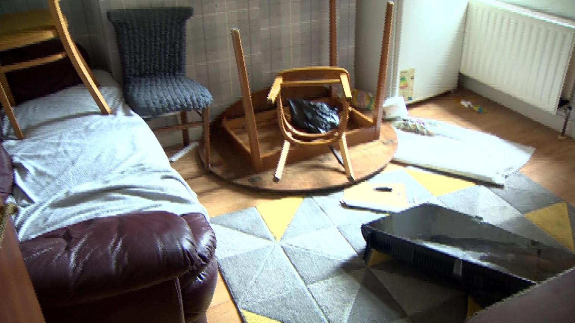 Rioters forced their way into the house breaking furniture and a television
A table has been overturned, a chair is on a sofa and a television is lyin broken on the floor