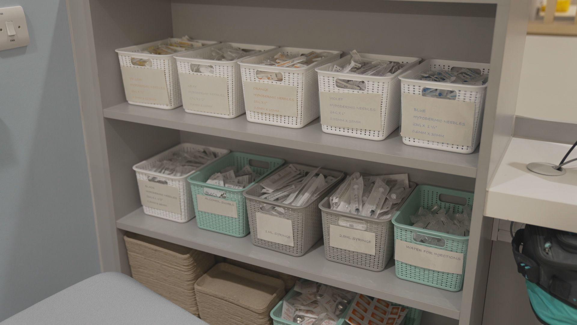 Medical equipment is safely packed in individual wrapping and in plastic boxes stacked on shelves.