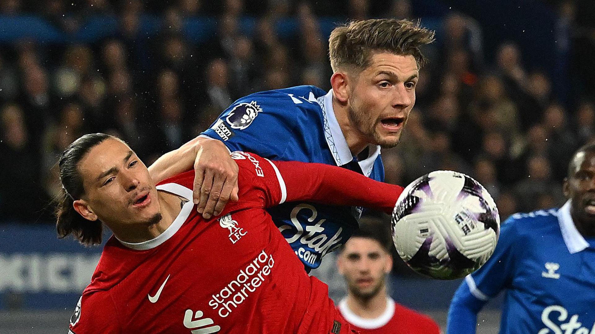 Darwin Nunez and James Tarkowski challenge for the ball