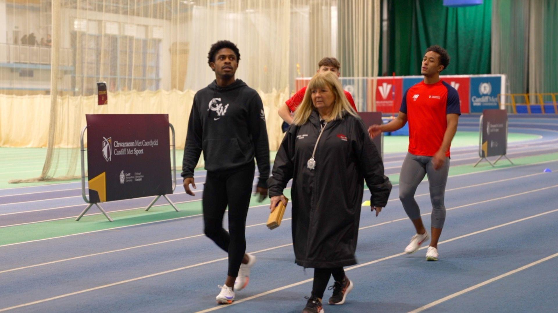 Coach Helen James works with Jeremiah Azu at NIAC in Cardiff.