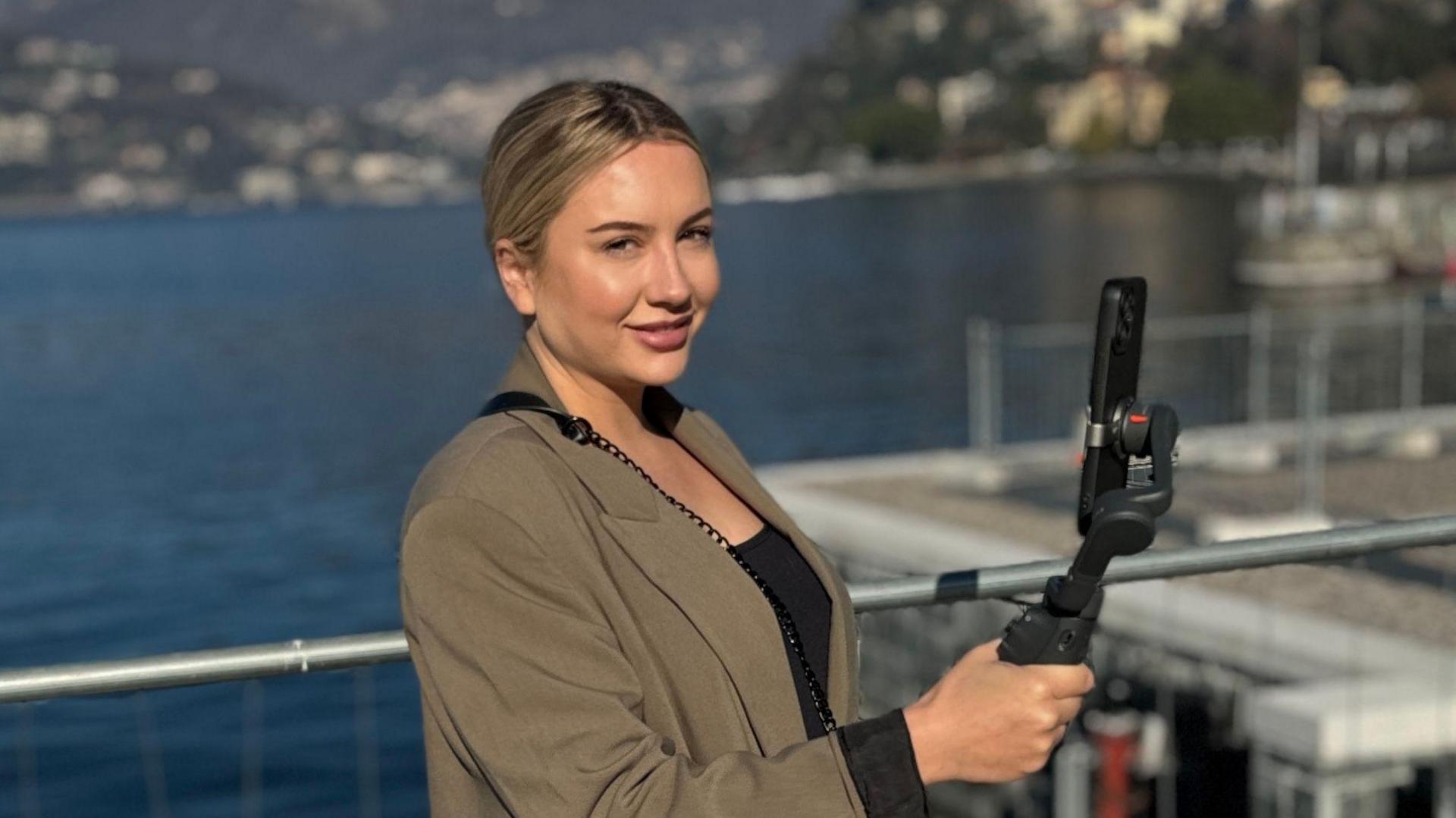 Tiffany Sciarrillo with camera equipment near a stretch of water