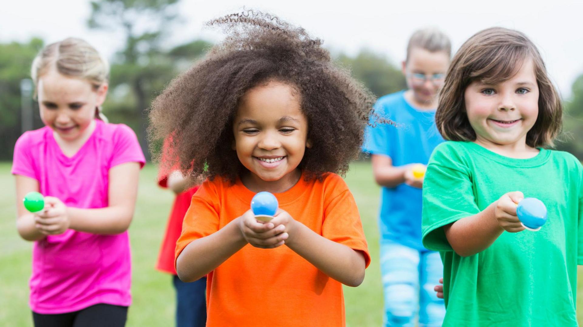 Children holding an egg and spoon