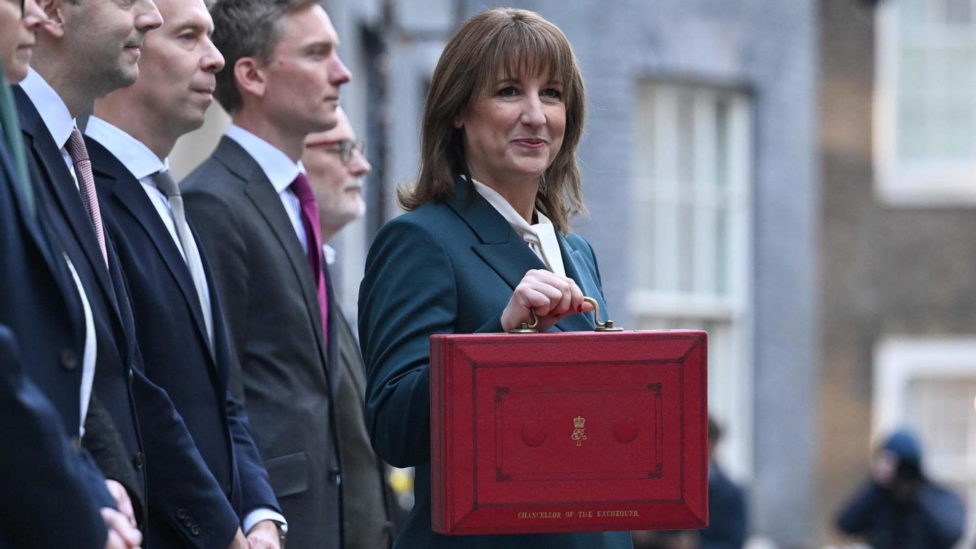 Rachel Reeves with a red box, stood next to treasury ministers in Downing Street.