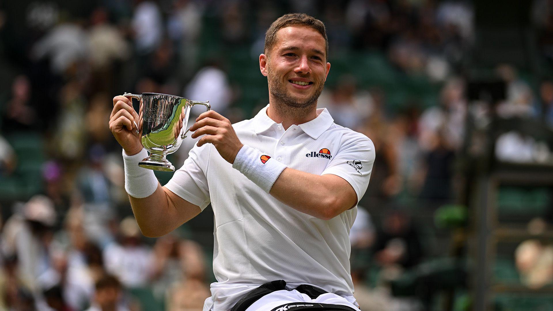 Alfie Hewett holds a trophy at Wimbledon