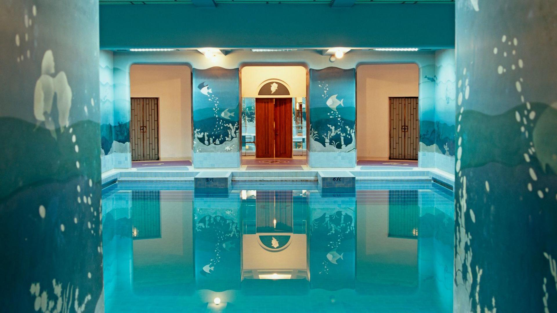 Seascape murals painted on the walls of the indoor swimming pool of Umaid Bhawan Palace - stock photo