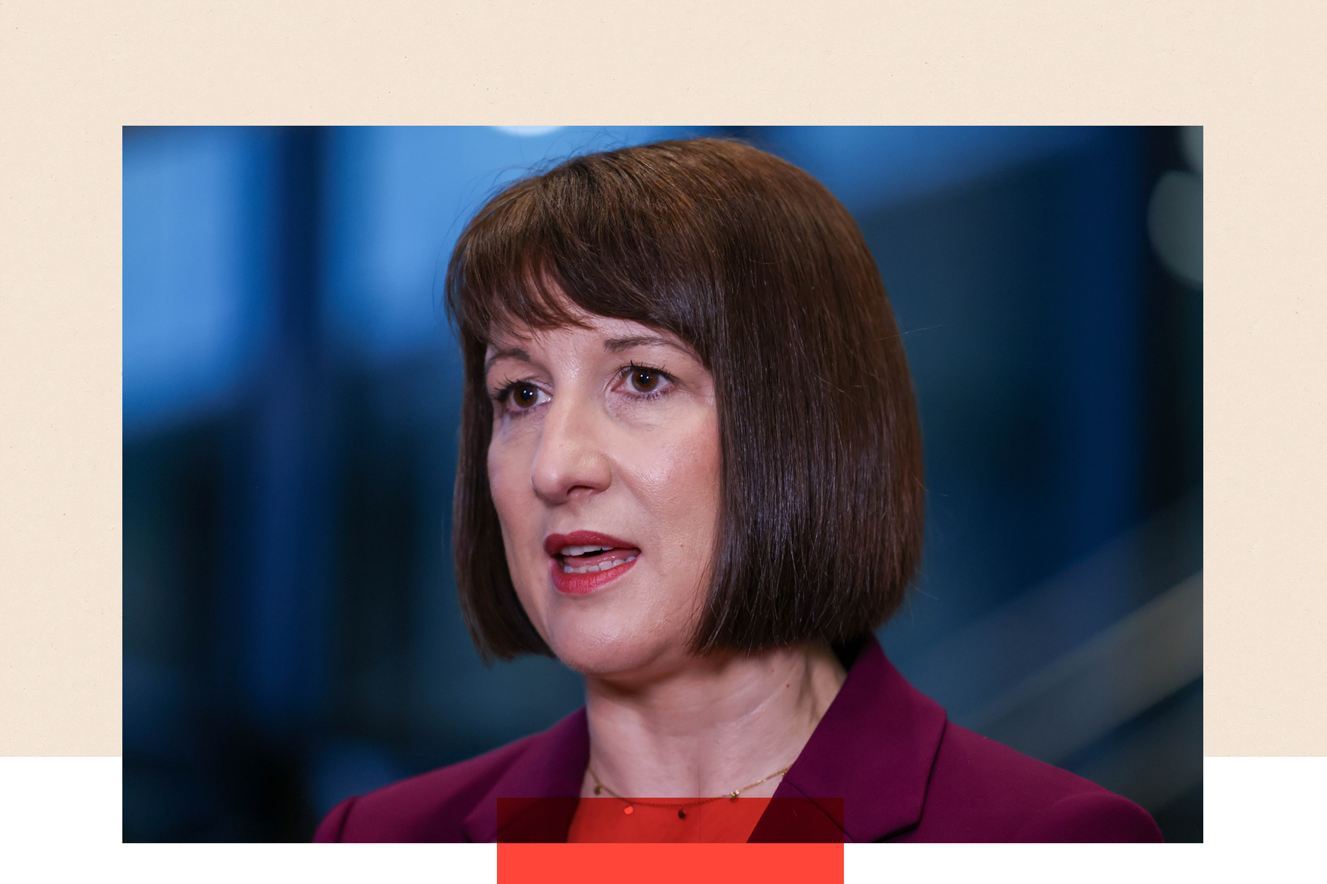 A close-up of Rachel Reeves during an interview at the UK Labour Party annual conference, captured mid-sentence with her mouth slightly open. She is wearing a gold necklace and a burgundy blazer, with her short bob and fringe hairstyle.