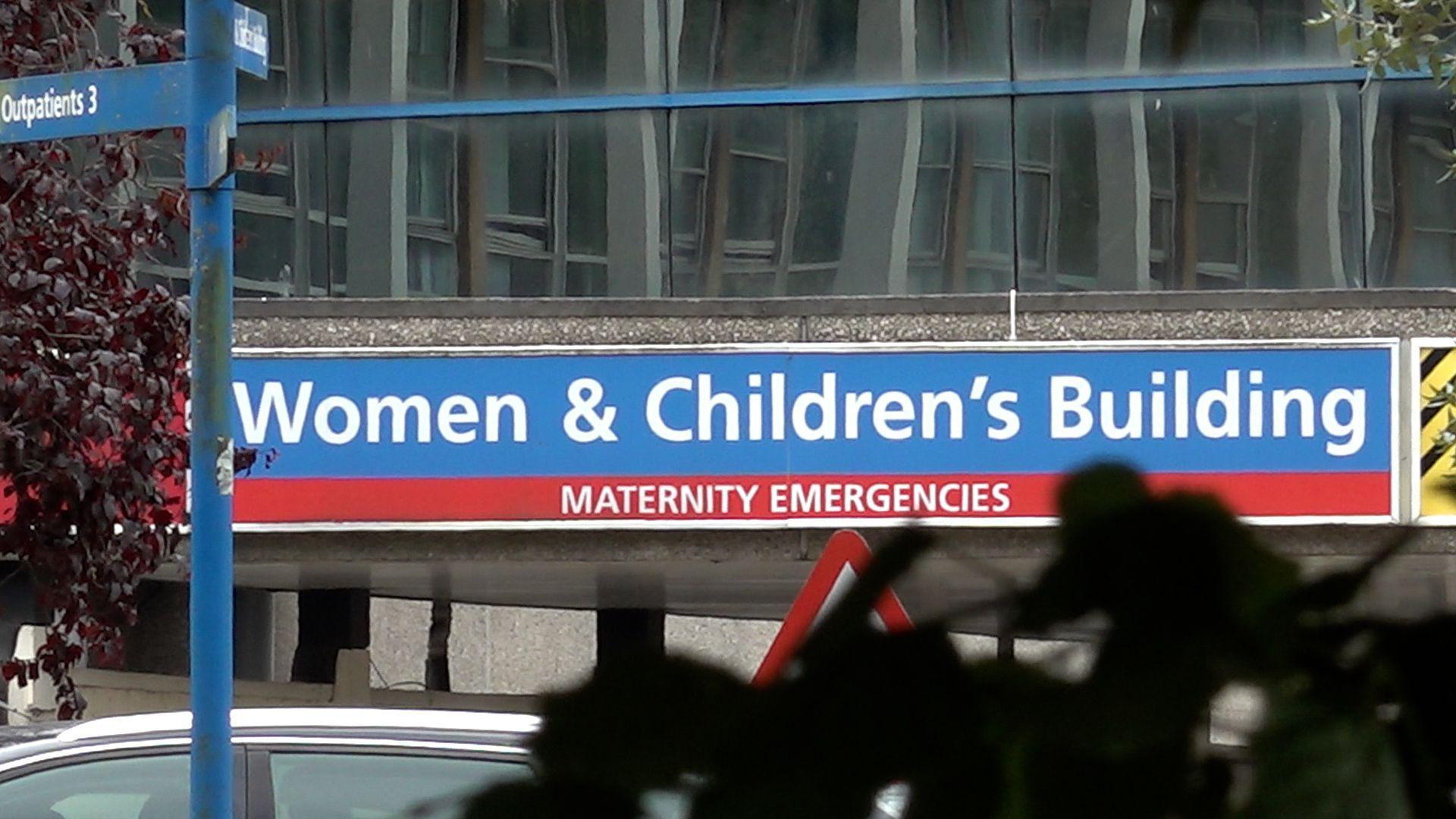Exterior of Chester's neonatal unit with blue sign above entrance saying Women and Children's Building - maternity emergencies.