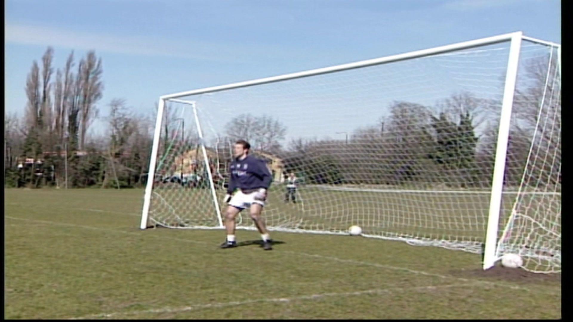 A picture of a goalkeeper stood in an oversized goal