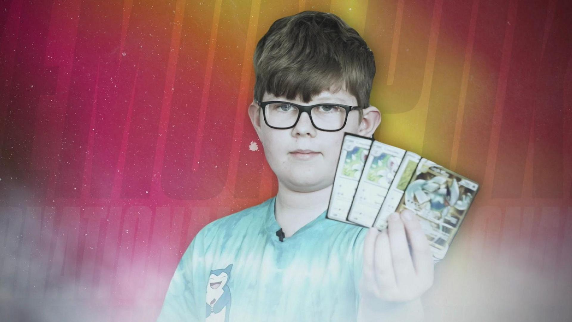 Boy showing his Pokémon cards 