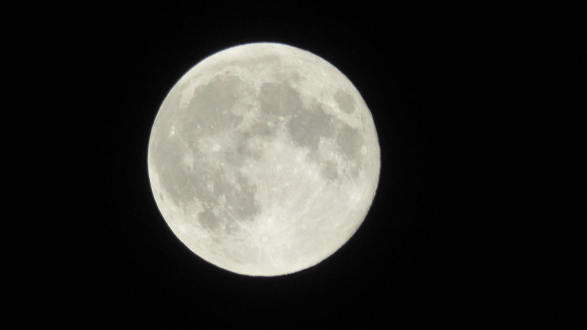 View of full Moon on a dark black background