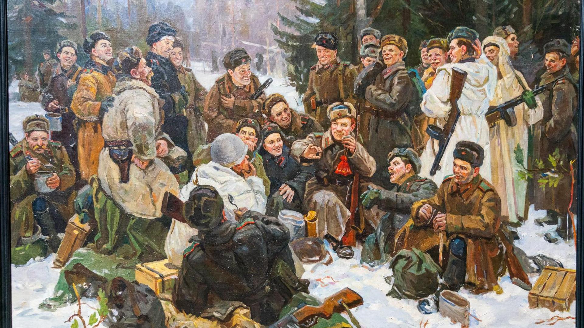 A painting of a group of soldiers in a forest in the snow - they are all in thick winter coats and wear winter hats with the communist symbol. They are standing and sitting in a group, smiling in conversation.