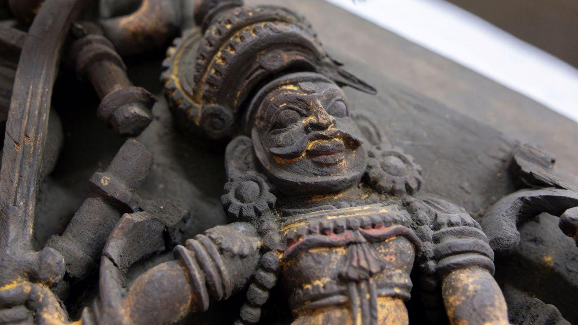 A frieze panel made of polychromed wood from the Kochi Ceiling with a Hindu deity.