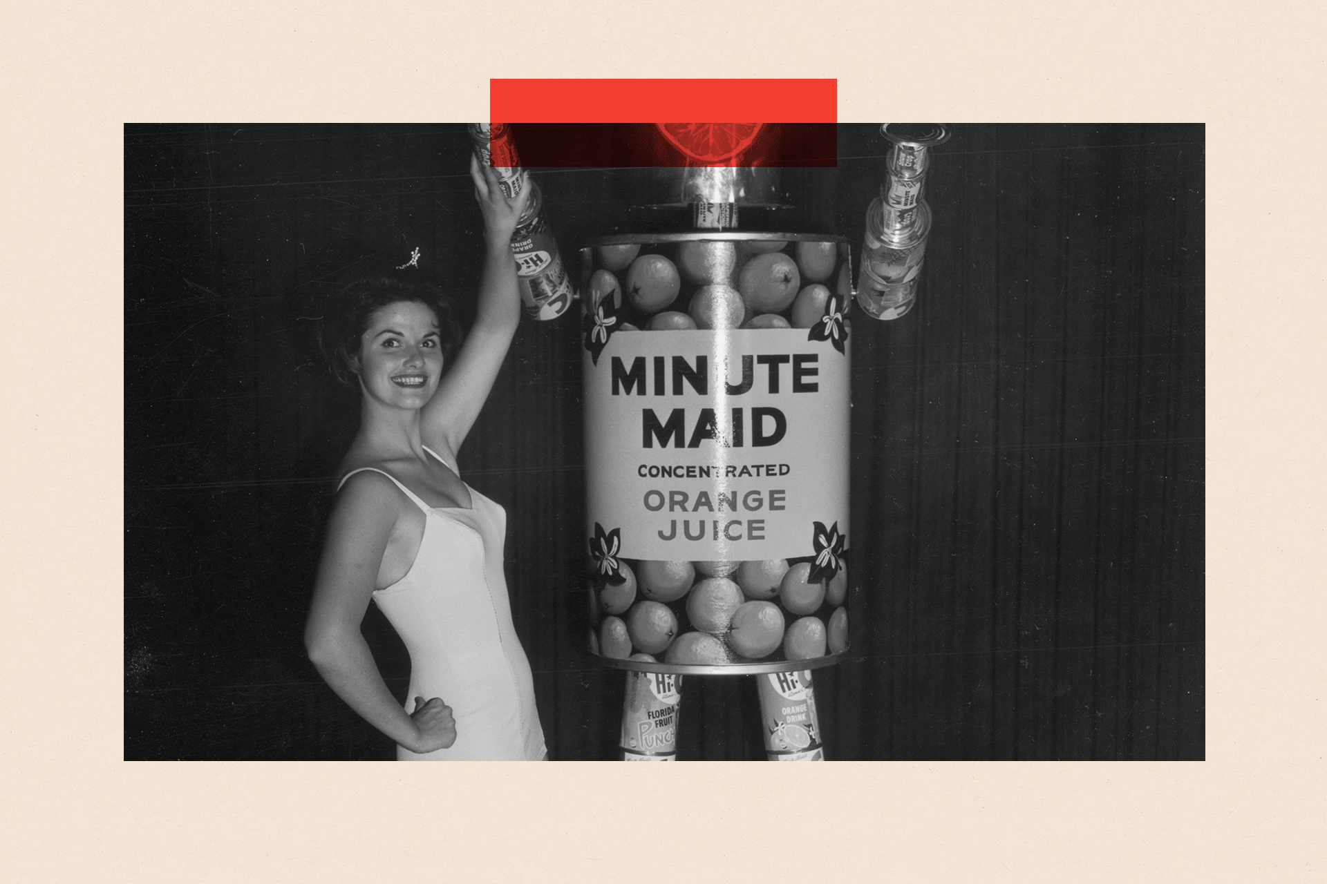 Full-length portrait of Marilyn Crane posing with Minute Maid's 'Mechanical Man' made from aluminum cans of orange juice