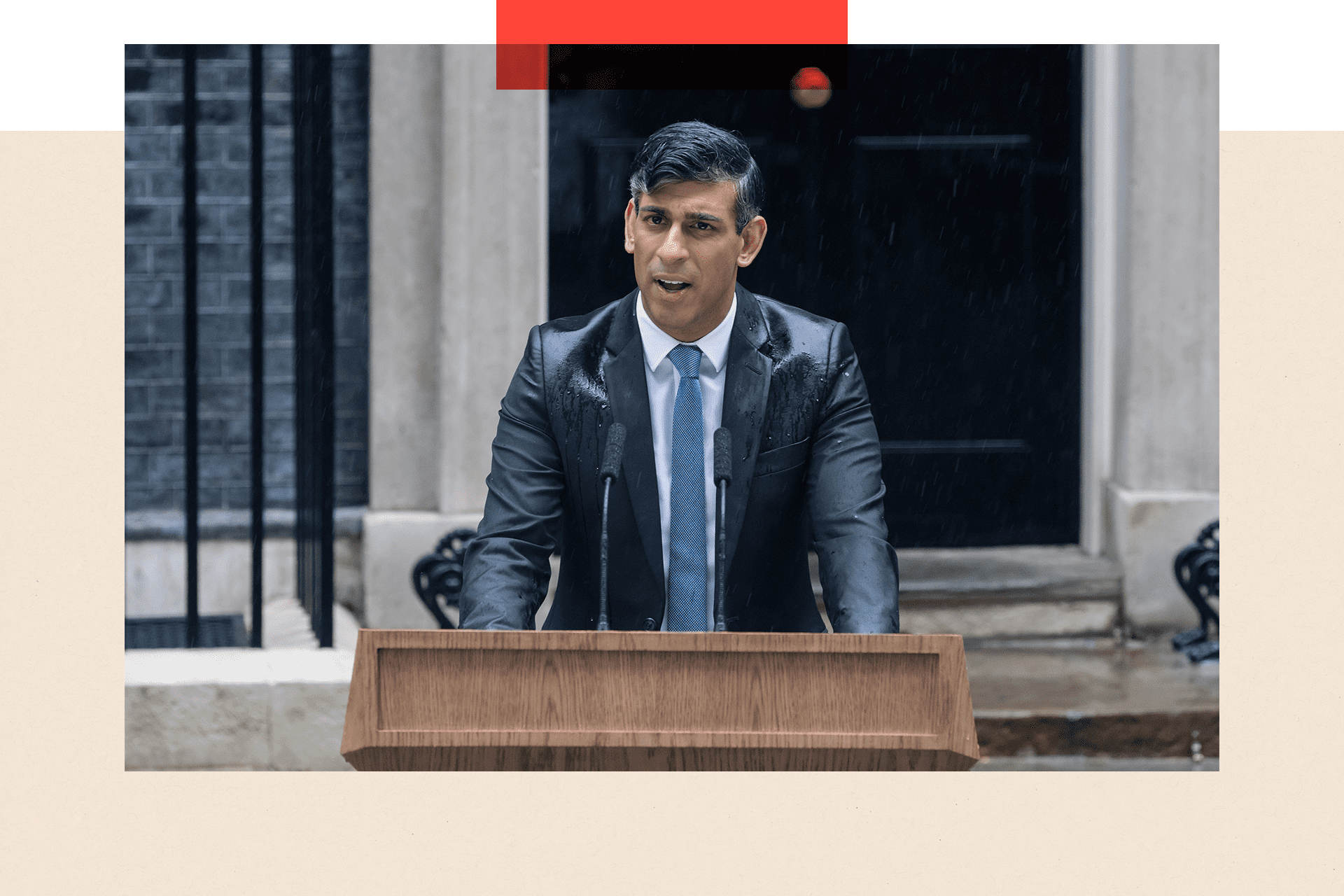 Rishi Sunak speaking at a lectern in a drenched suit in front of number 10 Downing Street