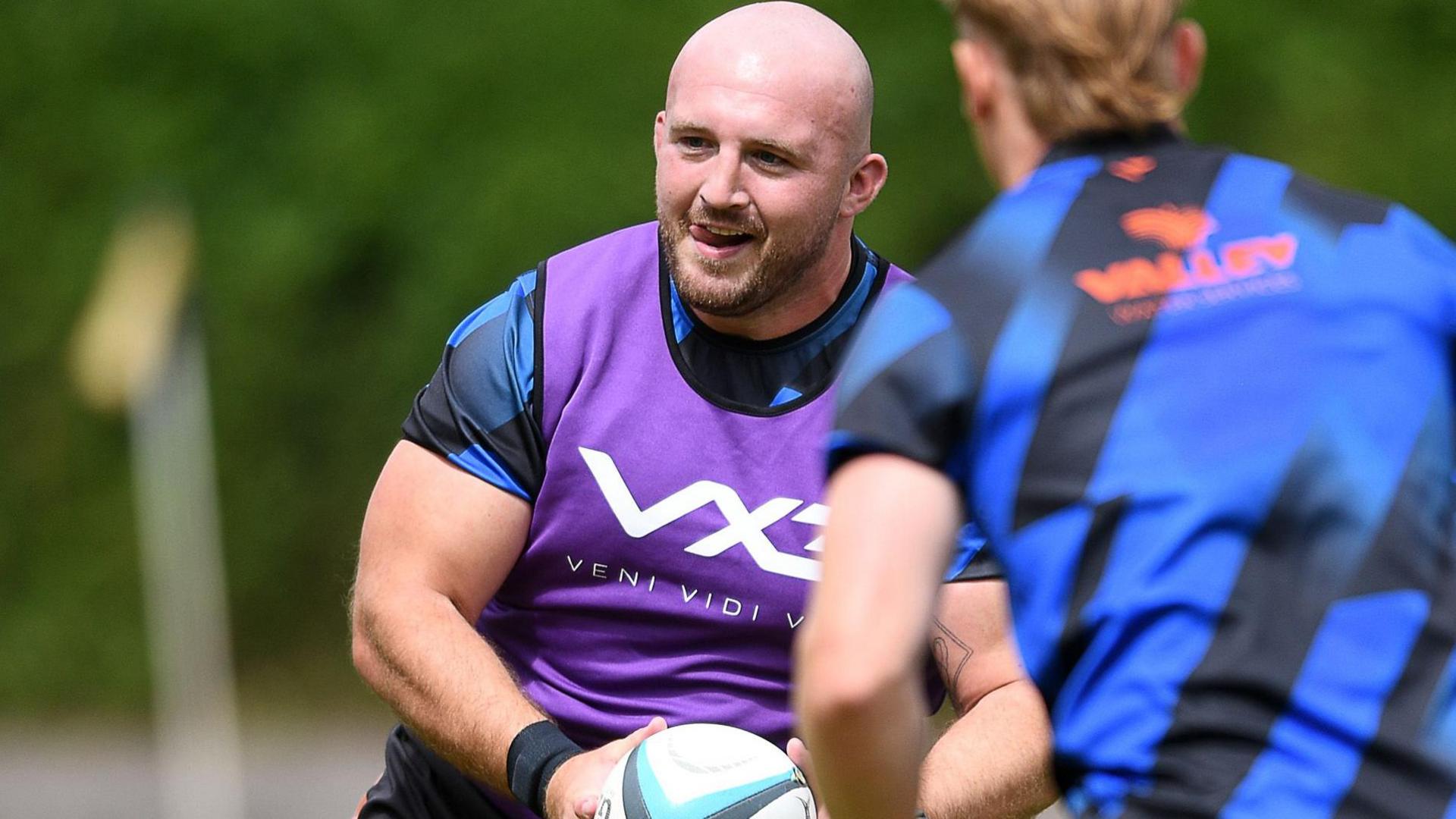 Dragons prop Dillon Lewis runs with the ball in training.