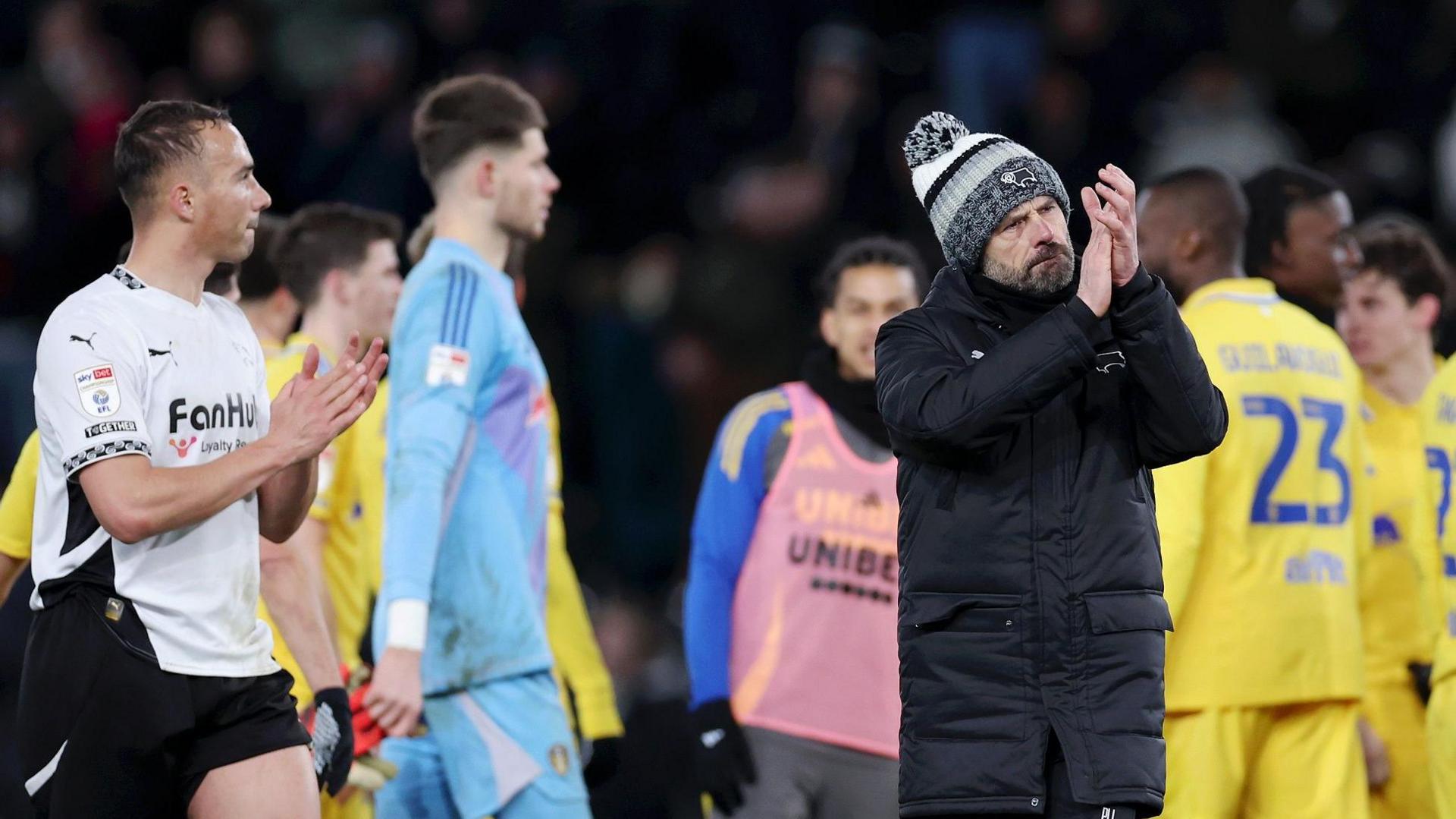 Derby boss Paul Warne claps in appreciation of Rams fans after their loss to Leeds