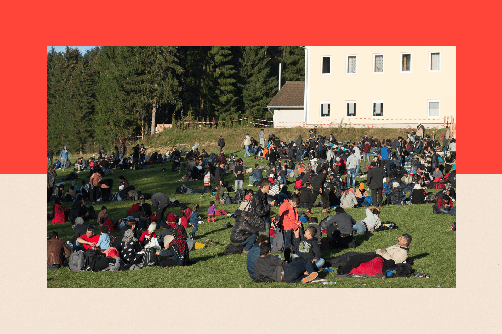 Refugees rest on a field in Wegscheid, Germany after crossing the Austrian - German border