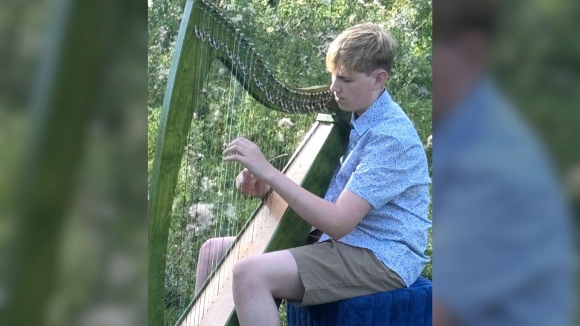 Freddie playing the harp outside