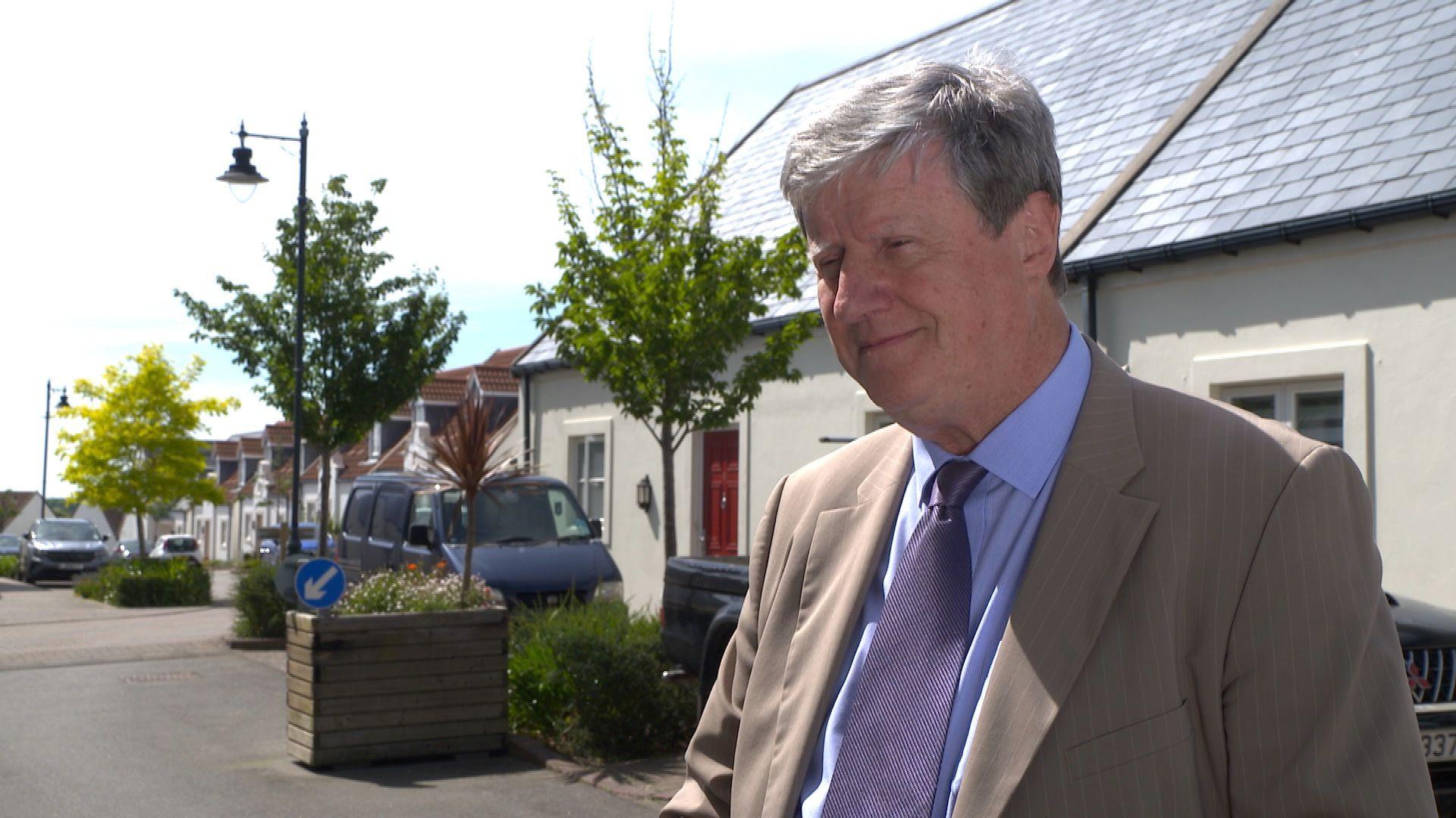 Constable Kevin Lewis standing outside social housing in Saint Saviour 