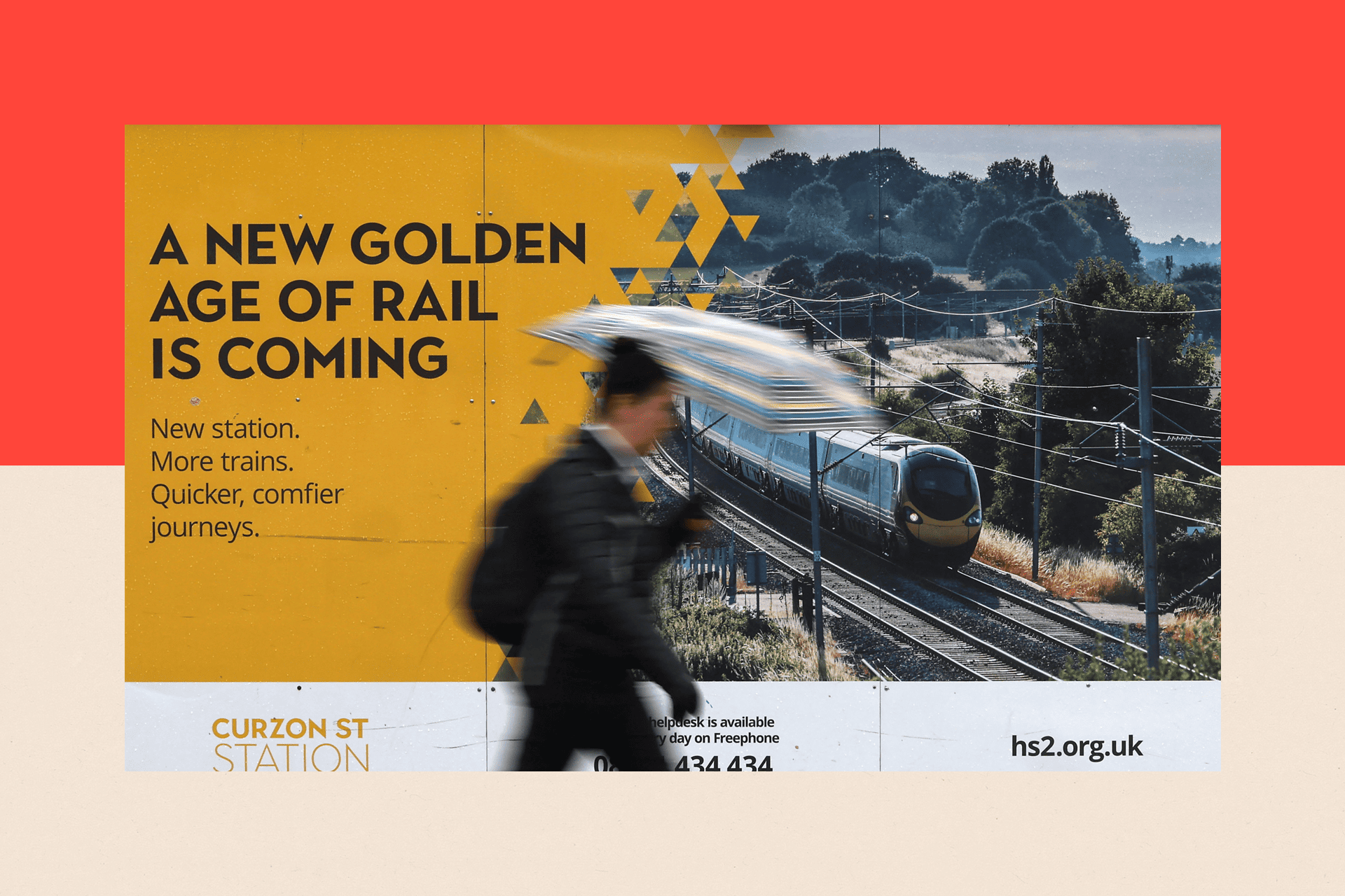 A person walks past a promotional billboard of the HS2 high speed railway